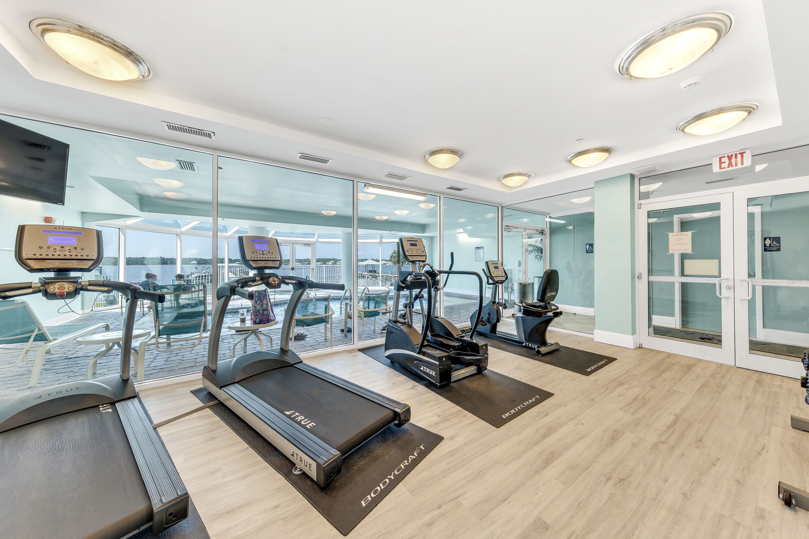 A gym with treadmills, ellipticals, and weight machines.