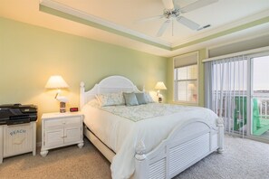 A bedroom with a bed, nightstands, a ceiling fan, and a view of the outdoors. - Sunset Island 6 Hidden Cove Way, Unit 3B (Ocean City)