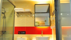 A bathroom with a glass shower enclosure, a white sink, and a red caution sign. - 7days Premium (Chongqing Tongliang Square) (Chongqing)