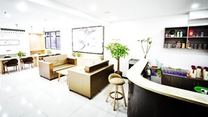 A modern interior with a bar area, seating, and a large poster on the wall. - 7days Premium (Chongqing Tongliang Square) (Chongqing)