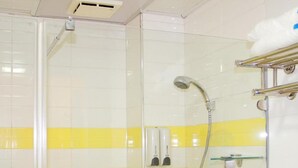 A bathroom with yellow and white tiles, a glass shower enclosure, a handheld showerhead, and a towel rack. - 7 Days inn Chongqing (Chongqing)