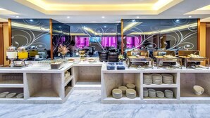 A modern hotel room with a marble floor, a buffet setup, and a television in the background. - Lavande Hotel (Chongqing)