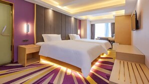 A hotel room with a large bed, bedside tables, a flat-screen TV, and a bathroom with a shower and toilet. - Lavande Hotel (Chongqing)