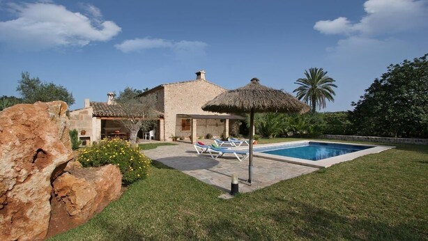 A villa with a swimming pool, lounge chairs, and a thatched-roof structure. - Villa Butxaco, One of the most popular, and for good reason (Pollença)