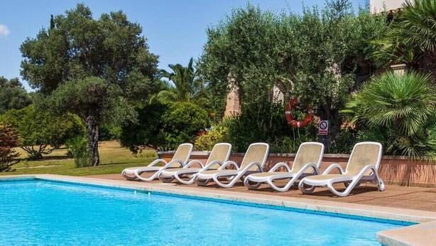 A swimming pool with lounge chairs and a no swimming sign. - Villa Hostalet,  Spaciousness and nature near the golf course (Pollença)