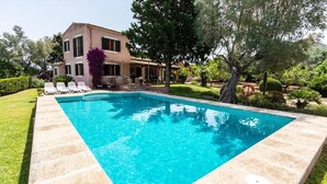A rectangular swimming pool with a clear blue water, surrounded by a stone deck. - Villa Alzina, Passion and care in every detail (Alcúdia)