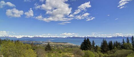 A mountainous landscape with a clear sky and a view of a lake.