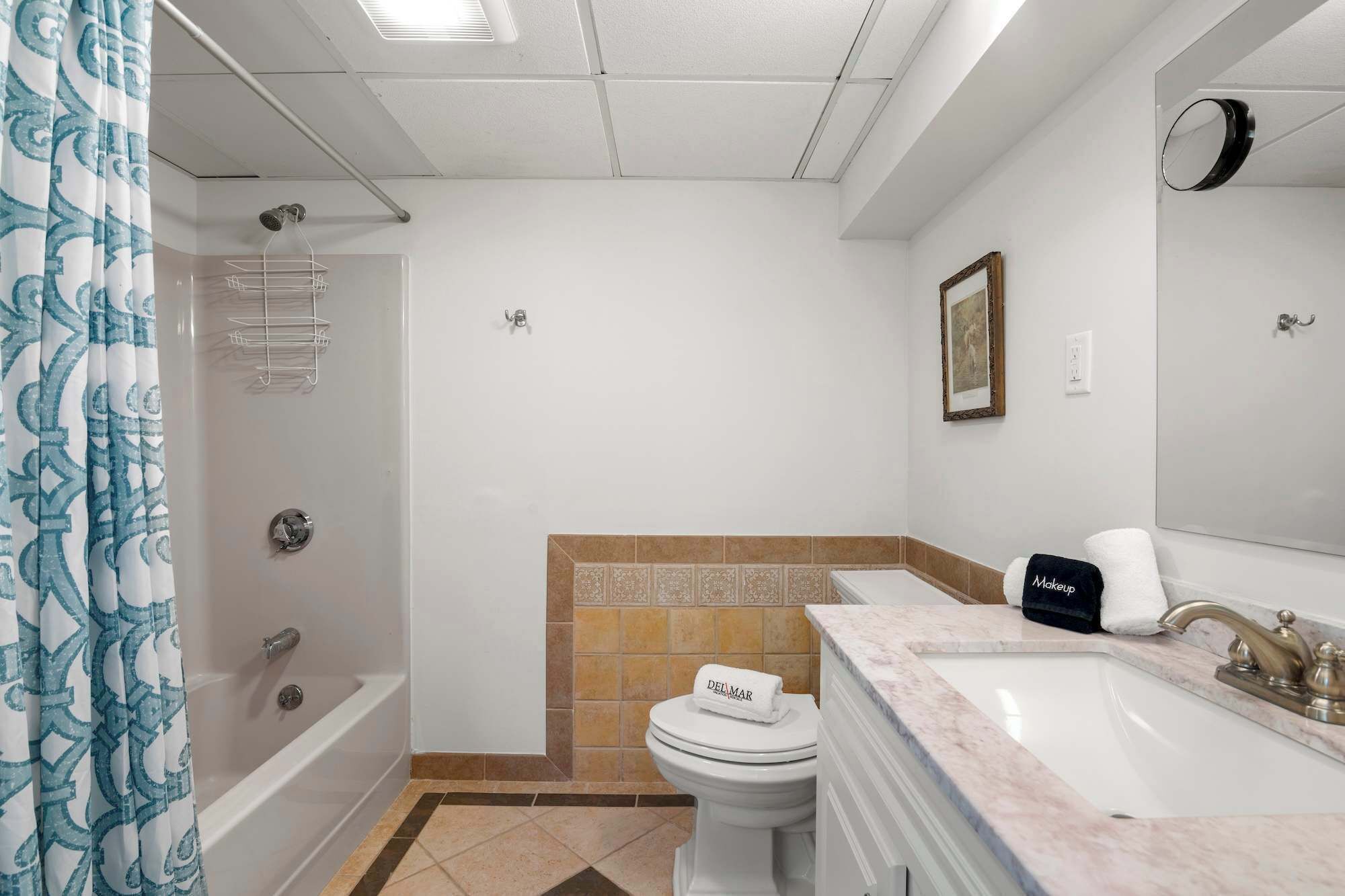 A bathroom with a bathtub, toilet, and sink.