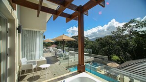 A modern outdoor pool area with a hot tub, lounge chairs, and umbrellas. - Owner-Rented Contemporary All-Inclusive Tropical Villa (Puerto Plata)