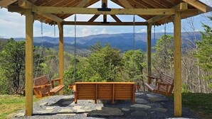 A wooden gazebo with a swing set, stone flooring, and a scenic mountain view. - Steamy Soaks with Scenic Views, Fireside Chats, Outdoor Showers & Game Nights - Jackson's Cabin (Sevierville)