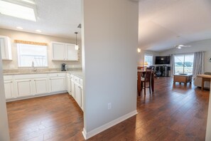 Enjoy a spacious living area with a modern kitchen, dining space, and comfortable seating.