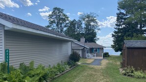 A residential property with a house number 4355, a covered porch, and a view of the lake. - All-Season Waterfront Home on SE Hubbard Lake! (Spruce)