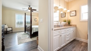 A bedroom with a four-poster bed, a ceiling fan, and a nightstand. - Private paradise! Gorgeous 4/3 Half duplex w/ private pool & dockage! (Marathon)