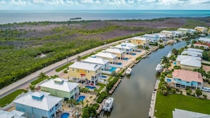 A waterfront resort with multiple buildings, a marina, and a clear view of the ocean. - Private paradise! Gorgeous 4/3 Half duplex w/ private pool & dockage! (Marathon)