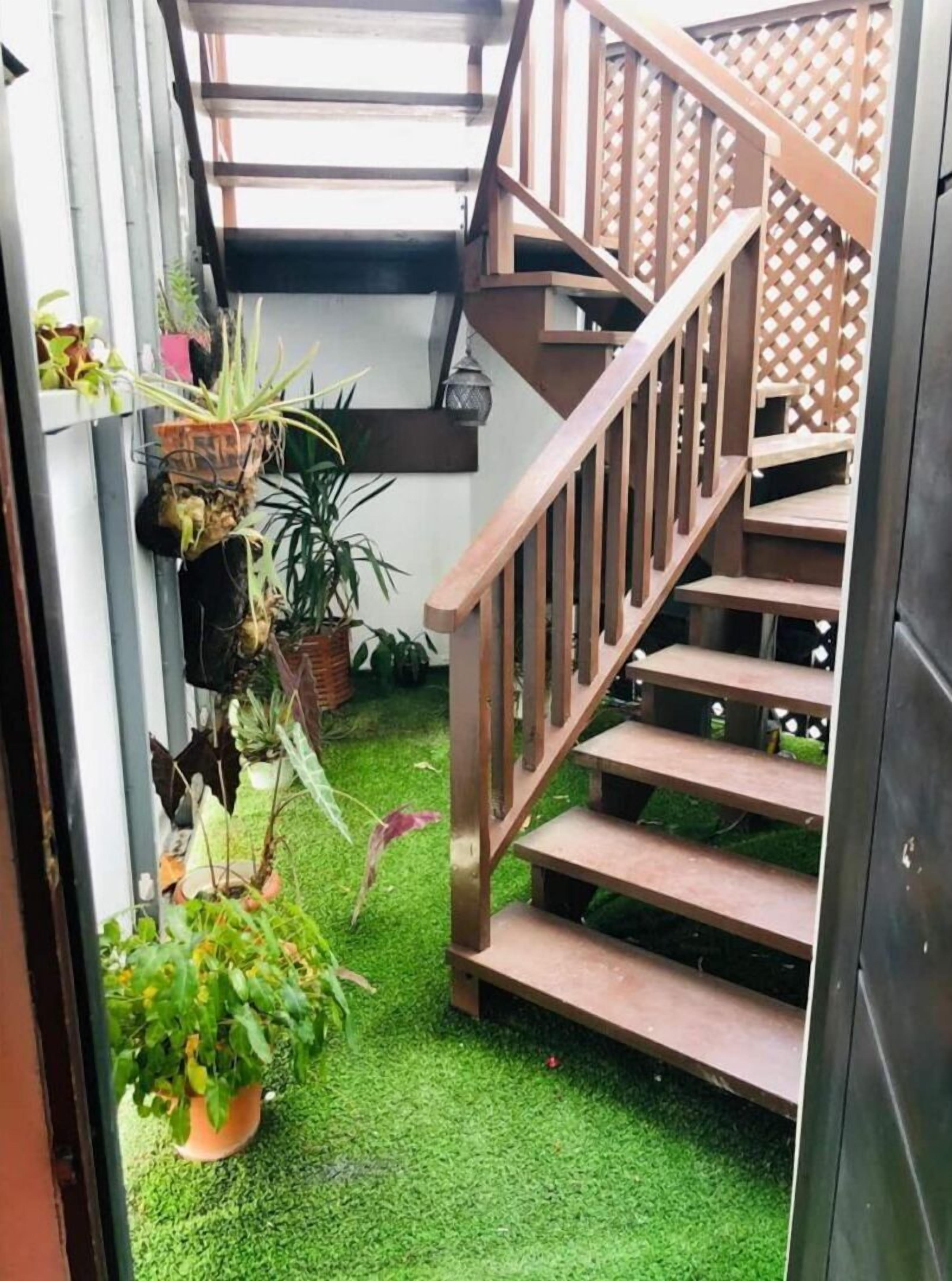 A staircase with wooden railings leading to an upper level.