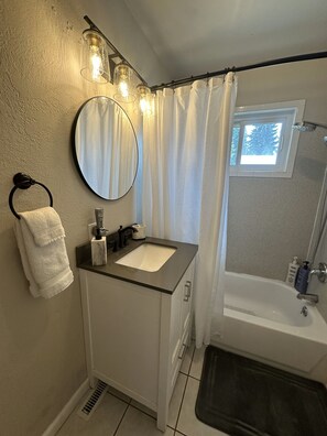 Combined shower/tub, hair dryer, towels, soap
