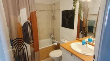 Bathtub, hair dryer, towels, soap