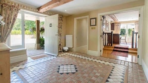 A spacious hallway with a tiled floor, wooden beams, and a view of the outdoors. - Stunning Country Farm House between Bristol & Bath (Bristol)