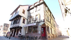 A restaurant named 'RESTAURANT PALMYRE' with outdoor seating on a cobblestone street.
