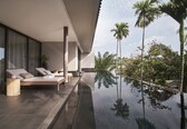 A modern outdoor lounge area with a reflective pool, lounge chairs, and a view of tropical vegetation.