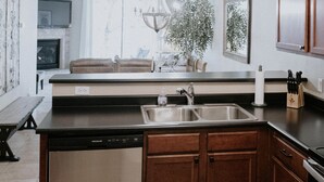 A modern kitchen with a dishwasher, sink, and wooden cabinets. - Waterfront Mesa Gilbert First Floor Gated Condo Golf Updated Clean Quiet (Mesa)
