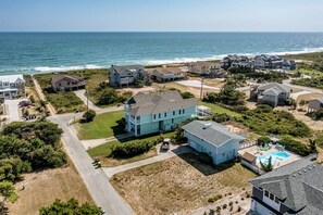 A coastal residential area with houses, a swimming pool, and a view of the ocean. - Sea View II | 245 ft to the beach | Private Pool, Hot Tub (Southern Shores)