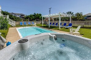 A backyard with a swimming pool, hot tub, and lounge chairs. - Sea View II | 245 ft to the beach | Private Pool, Hot Tub (Southern Shores)