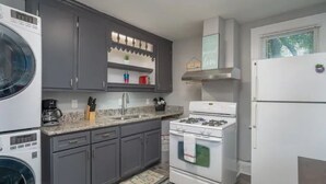 A kitchen with grey cabinets, a white stove, a white refrigerator, and a coffee maker. - Vibrant, Historical Escape in Phoebus! (Hampton)