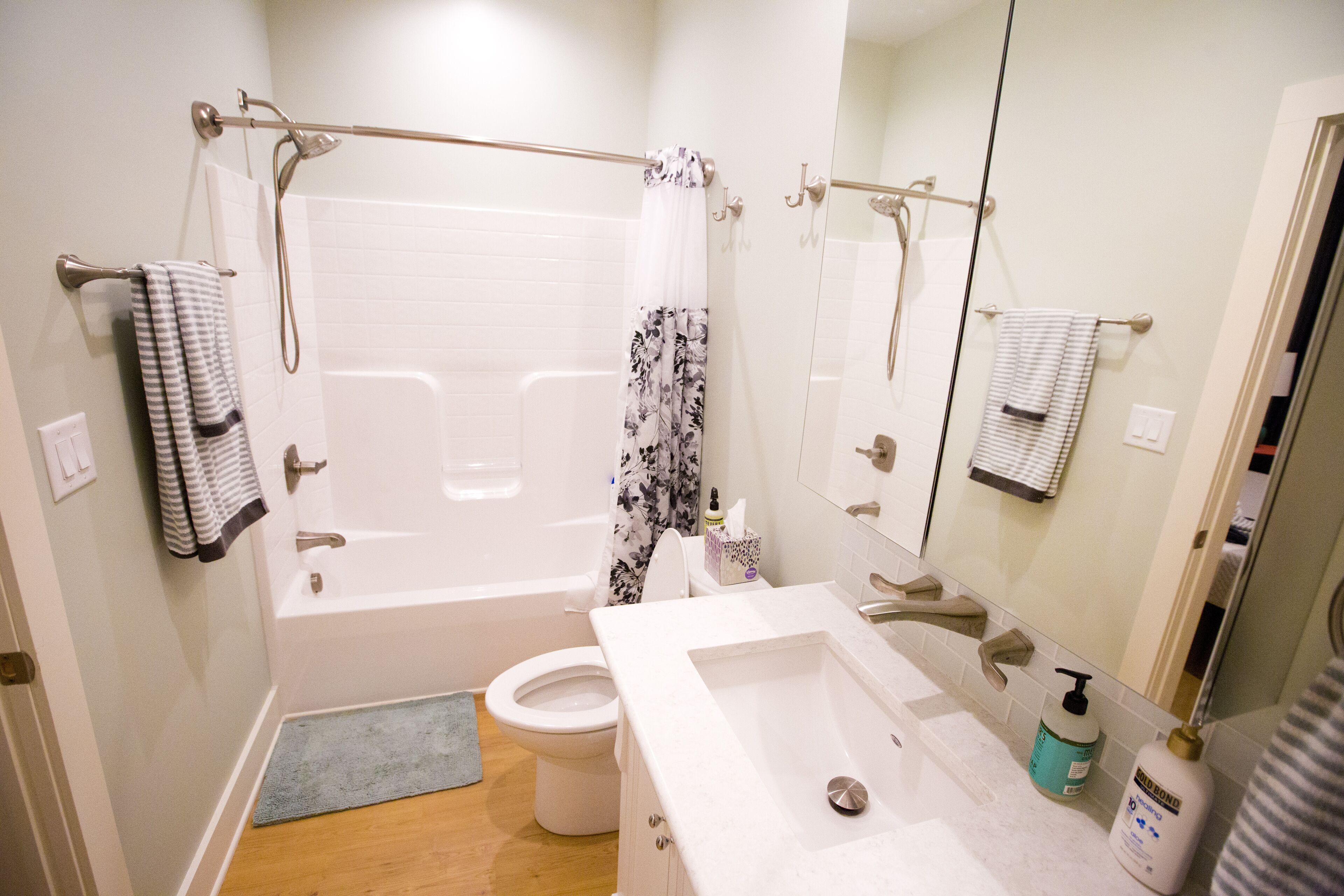 A bathroom with a bathtub, toilet, and sink.