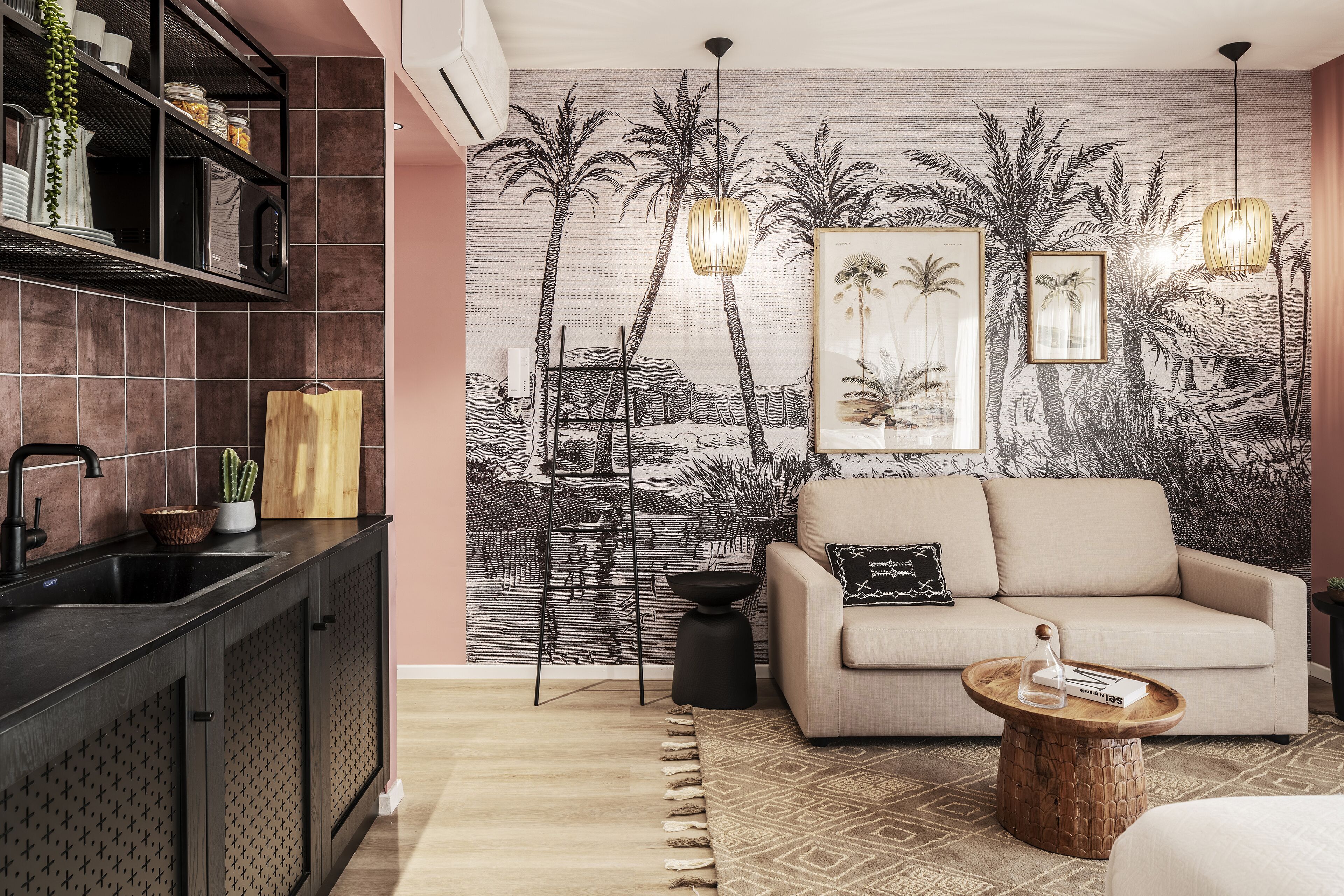 A modern living room with a sofa, a coffee table, and a kitchen area with a sink and shelves.