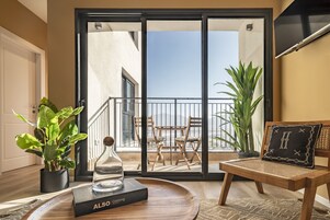 One Bedroom Apartment with Balcony | Living room | 40-inch Smart TV with cable channels, TV