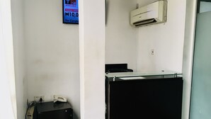 A hotel room with a desk, a telephone, an air conditioning unit, and a sign indicating WiFi availability. - Demiral Hotel Ikeja (Lagos)