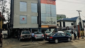 A building with a sign for 'The Place' and 'Phantom' on the facade. - Demiral Hotel Ikeja (Lagos)