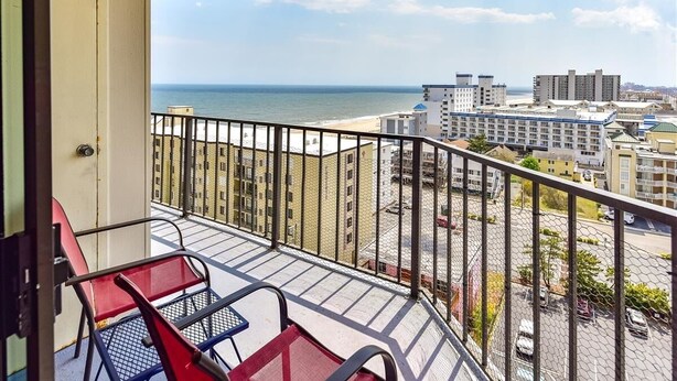 A balcony with a view of the beach and cityscape. - Sweeping ocean and bayviews, large outdoor pool,2 Br/2 Ba. (Ocean City)