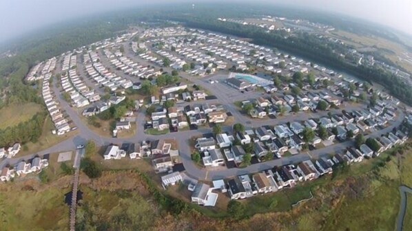 A large, circular layout of mobile homes with a central road and surrounding greenery.