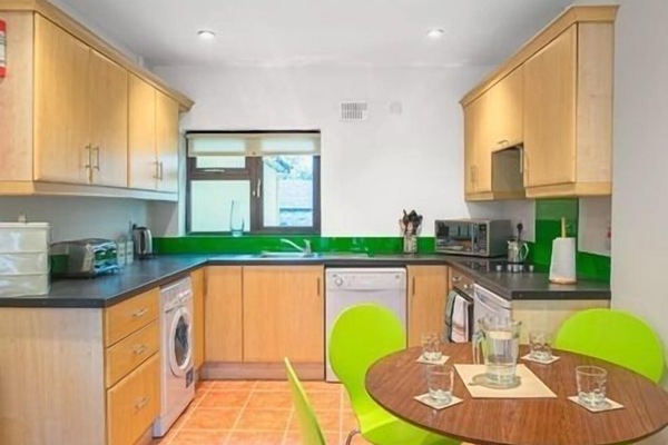 Fully fitted well equipped kitchen has crockery and utensils with oven, hob, microwave, dishwasher, washer/drier