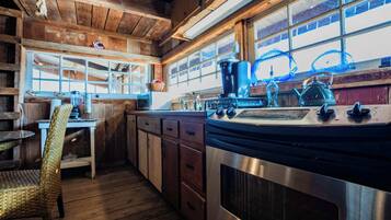 Fridge, microwave, coffee/tea maker, cookware/dishes/utensils