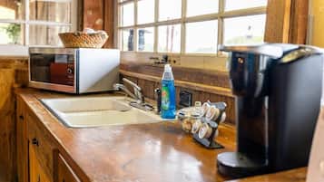 Fridge, microwave, coffee/tea maker, cookware/dishes/utensils
