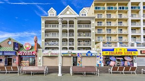 A beachfront hotel with multiple balconies, a candy kitchen, and various shops.