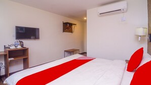 A hotel room with a bed, a TV, a desk, and a wardrobe. - OYO 562 K Garden Hotel (Sungai Petani)
