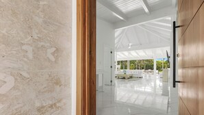 A spacious, modern interior with a high ceiling and natural light. - Close to Minitas Beach (La Romana)