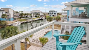 A waterfront property with a pool, dock, and multiple buildings.