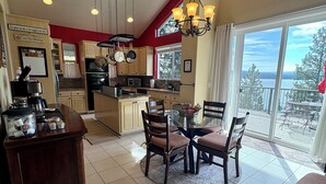 A kitchen with a dining area, a coffee station, and a view of the outdoors.