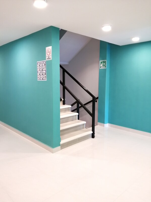 A staircase with black railings leading to a landing.