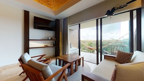 A modern living room with a wooden table, chairs, a sofa, and a large window offering a view of a bridge and greenery.