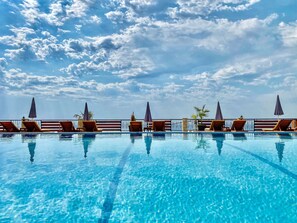 Seasonal outdoor pool, open 9:00 AM to 9:00 PM, free cabanas