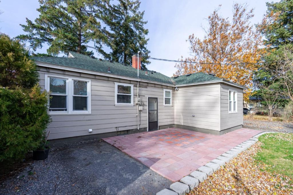 A two-story house with a front porch, a garage, and a driveway.