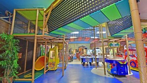An indoor play area with climbing structures, a play table, and arcade games. - Regal Palms Resort  Communal Pool, Arcade, Fitness Center & Tennis (Davenport)