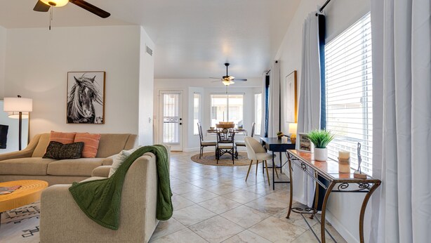 A spacious living room with a sofa, coffee table, and a dining area with a table and chairs. - Beautiful 2/2 in Springfield 55+ Golf Community 30 night minimum (Chandler)