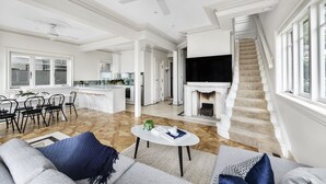 A spacious living area with a fireplace, a dining area, and a kitchen.